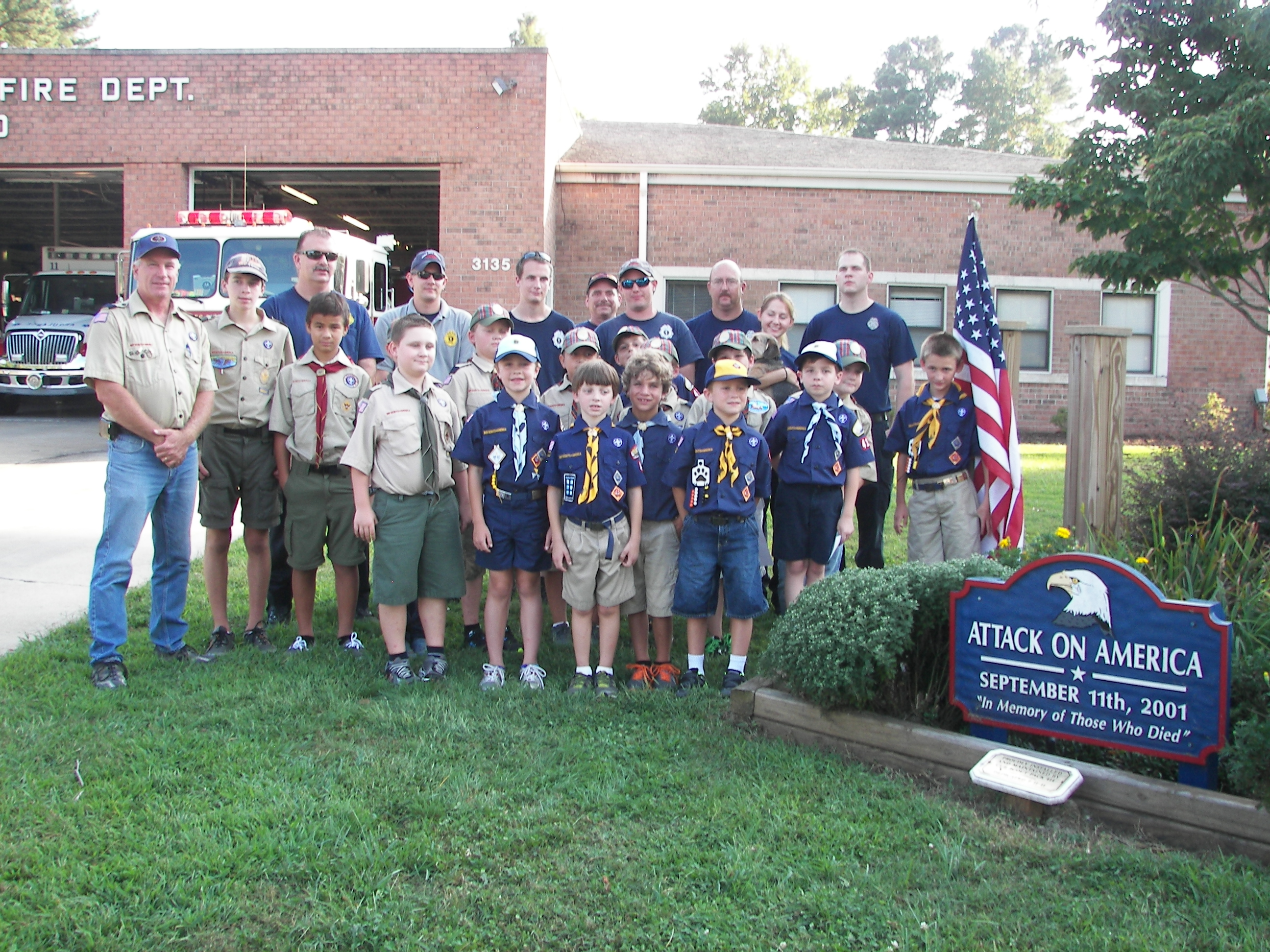 Cub Scouts pose with members of the James-City Bruton Volunteer Fire Department at a ceremony at the firehouse on Wednesday. (Photo courtesy Darrell Wahl)