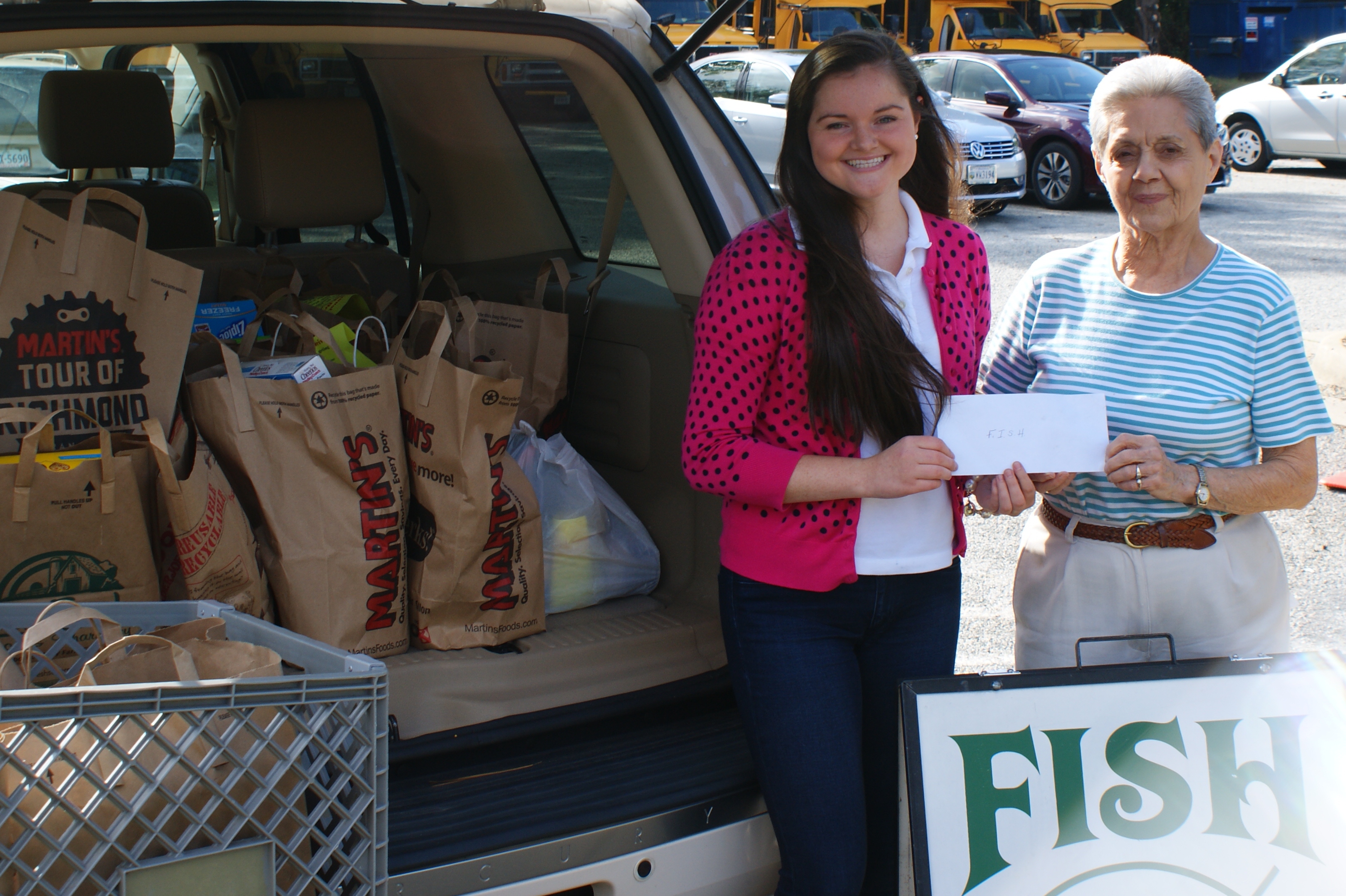 Kelly McGregor with Billie Johnston, Director of FISH after McGregor's most recent food drive. Johnston was also presented with a monetary donation.