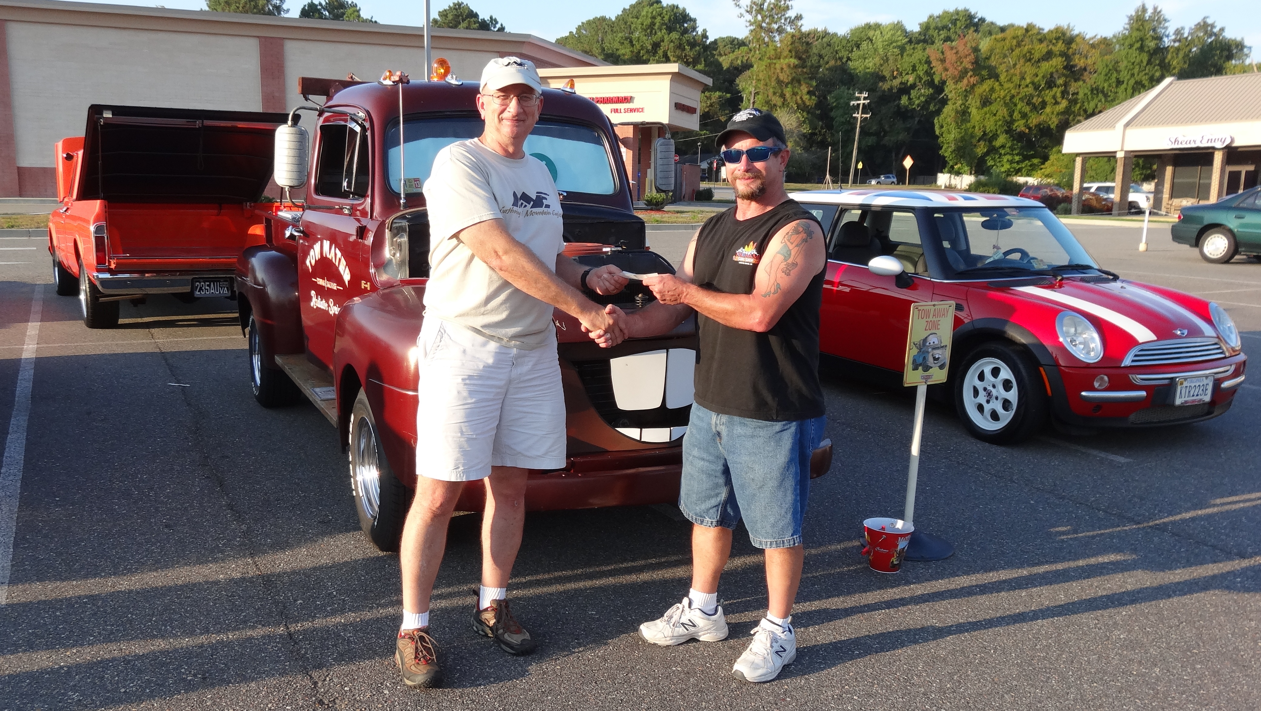 Blair Armbrister (Right) President of the Classic Cruisers Car Club presents a check to Woody Aurentz of Yorktown (left), Executive Director of the Gathering of Mountain Eagles