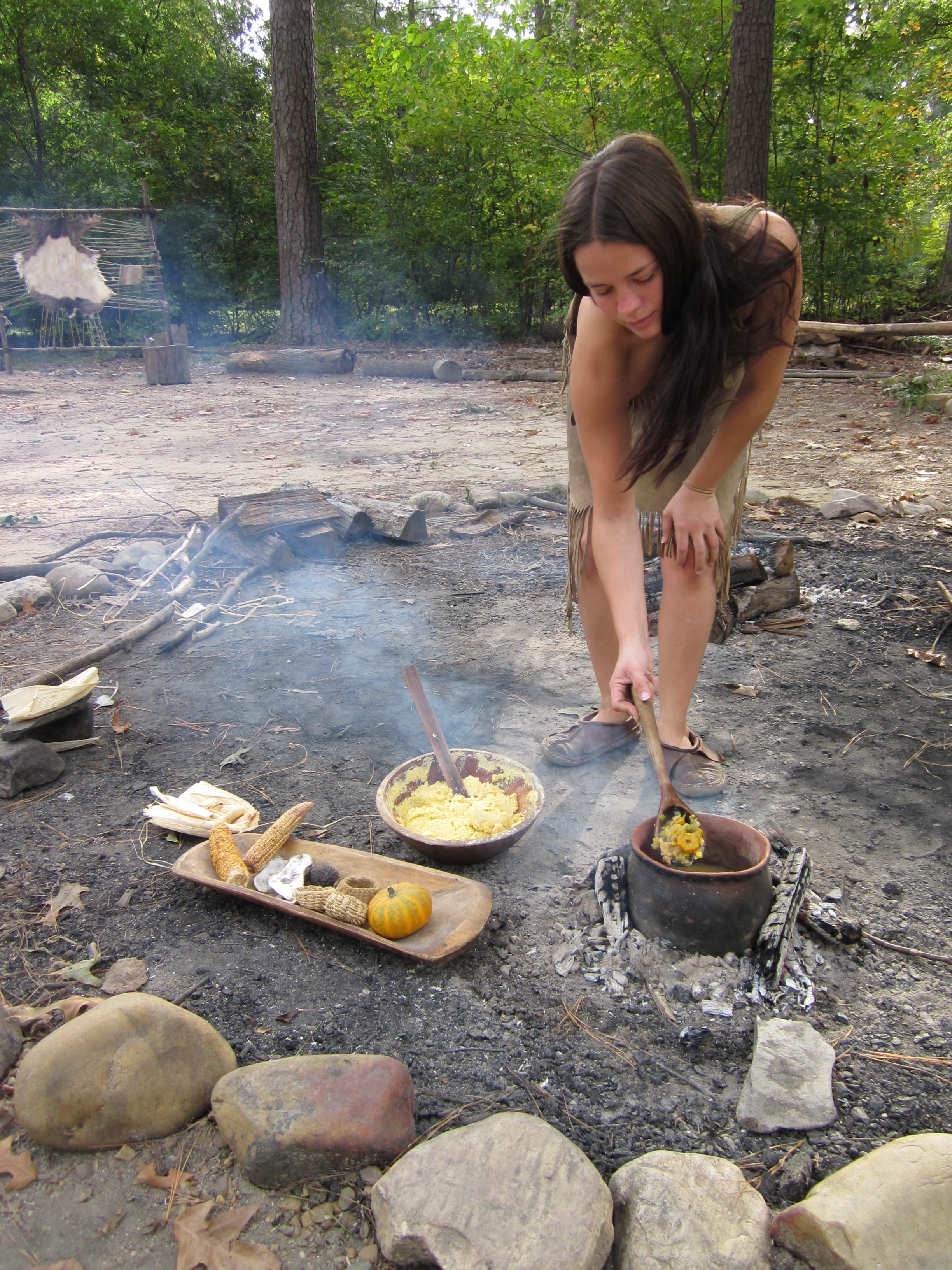 Stirring a pot of stew in Jamestown Settlement's re-created Powhatan Indian village. Jamestown-Yorktown Foundation photo.