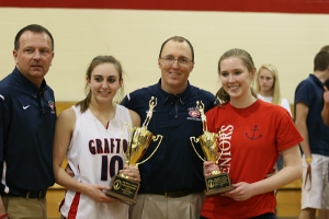 Tommy Bayse (middle) hoists the 2011 Bay Rivers District tournament trophy alongside assistant Pat Huffman (far left), Morgan Heath (left) and Alaina Baxley (right).