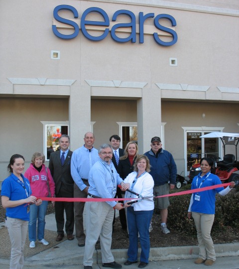 Sears Hometown Store owner John Jakobs and his wife, Kathy, cut the ribbon to celebrate the store's grand opening. (Photo courtesy James City County)