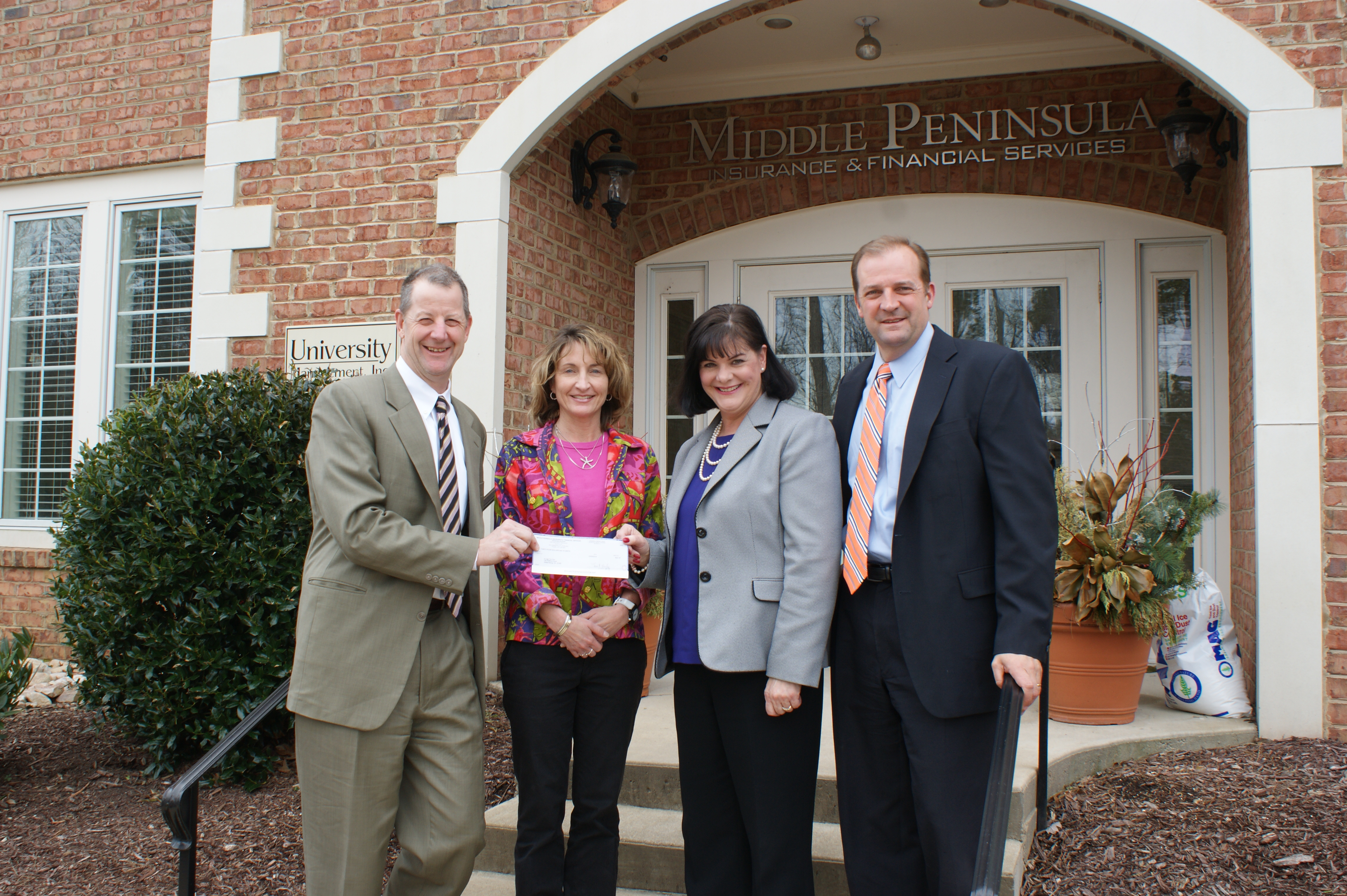 Pam McGregor, director of development and marketing at Williamsburg Christian Academy, accepts a sponsorship check from Bill Morrison of Middle Peninsula Insurance in support of WCA's 7th annual Soar Like Eagles luncheon. Pictured from left is Morrison; Terri Drake, Middle Peninsula; McGregor; and Steve Rice, Middle Peninsula.