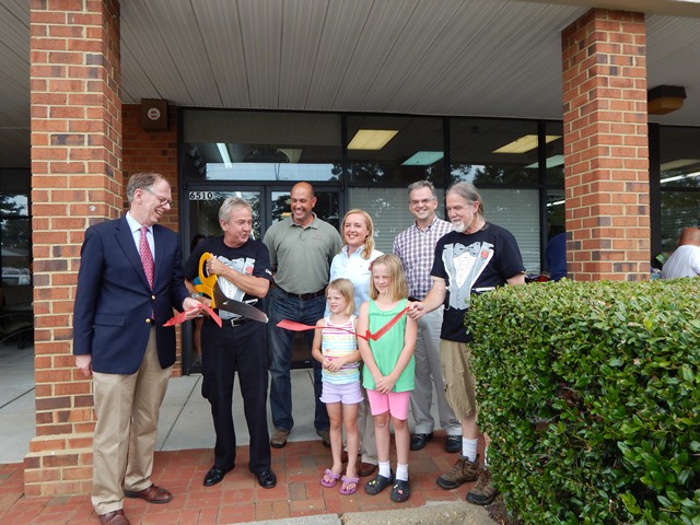 Supervisor John McGlennon (Roberts), Charlie Crawford, Supervisor Michael Hipple (Powhatan), Chairwoman Mary Jones (Berkeley) and Assistant County Administrator Adam Kinsman celebrate the newest location of Charlie's Antiques with a ribbon cutting. (Photo courtesy James City County)