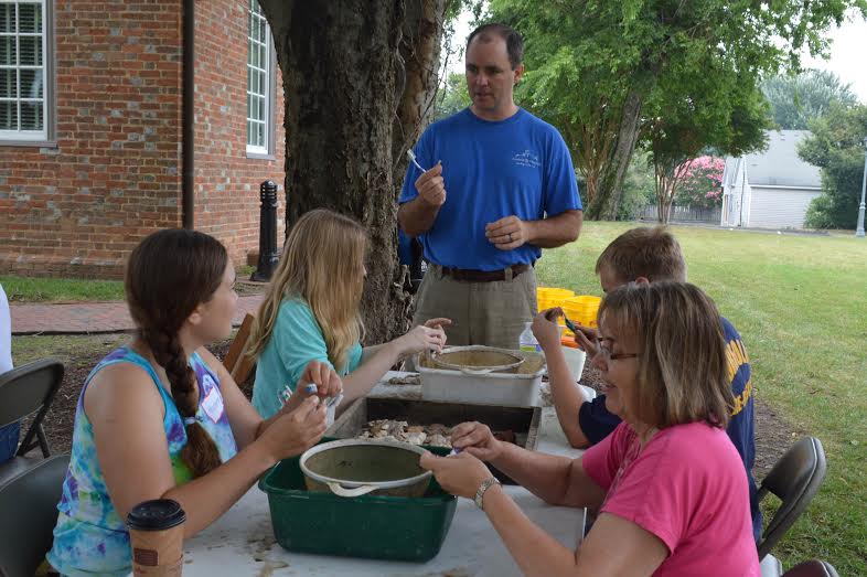 Volunteers wash and sort artifacts in June (Submitted)