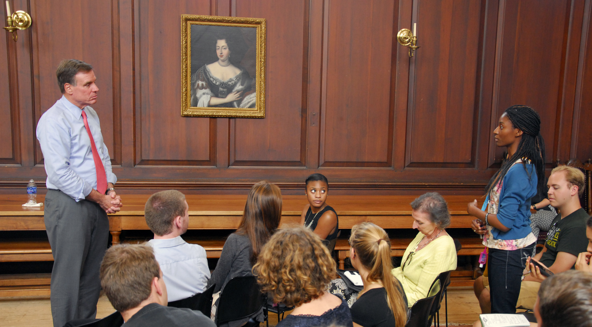 Sen. Mark Warner (left) listens to a question from a College of William & Mary student during a conversation Tuesday at the Wren Building concerning student loan debt. (Gregory Connolly/WYDaily)