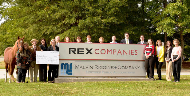 Nancy Paschall, executive director of Dream Catchers, “Red” and the staff of Malvin, Riggins + Company, PC at the company’s corporate headquarters in Newport News (Submitted)
