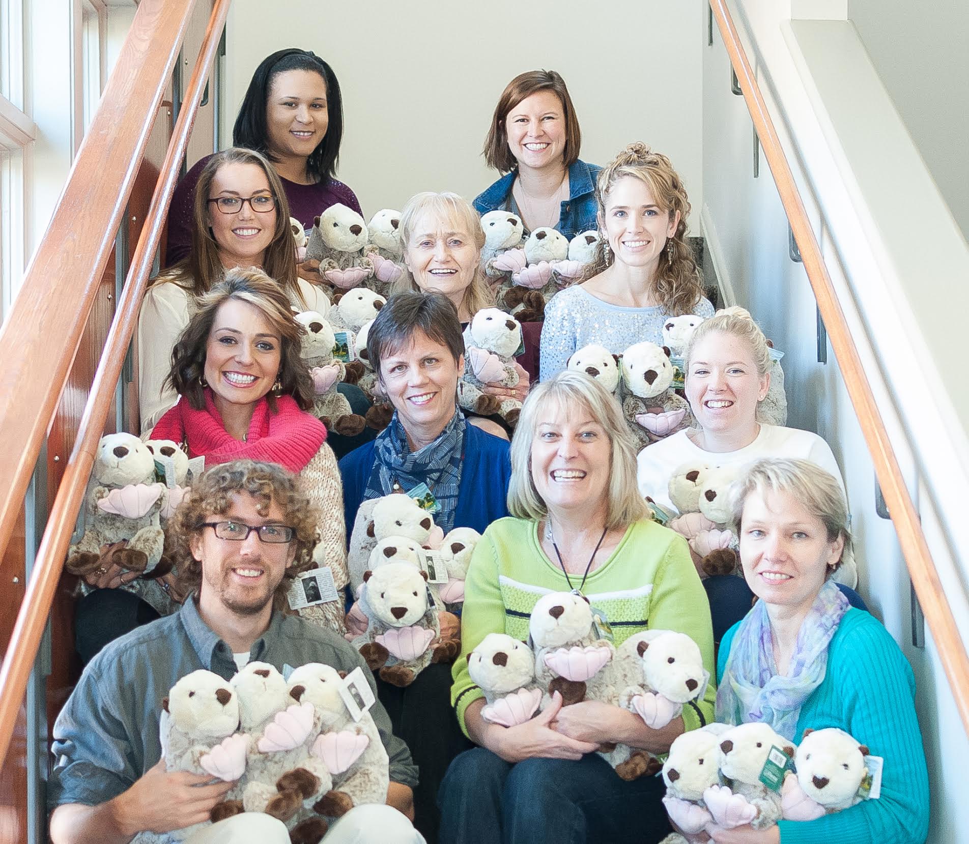 Howell Creative Group team members with stuffed otters to go to area children. (L to R) Row 1: John Thomas, Kandy Baker, Svetlana Gotra. Row 2: Tiffany Reaves, Kathy Howell, Dreama Spence. Row 3: Ariel Zimmerman, Marie Halpin, Christy Keeler. Row 4: Tahitia Banks, Kelsey Sanders (Submitted)