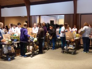 Volunteers from Veritas Preparatory School and Saint Bede Catholic Church help at the church's mobile food pantry. (Photo courtesy Saint Bede Church)