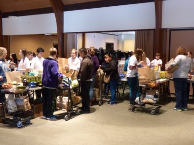 Volunteers from Veritas Preparatory School and Saint Bede Catholic Church help at the church's mobile food pantry. (Photo courtesy Saint Bede Church)