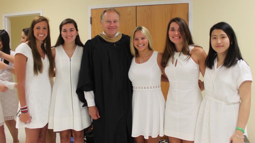 HRA Headmaster Peter W. Mertz stands with members of the class of 2015 before the Commencement Ceremony. (Courtesy Hampton Roads Academy)