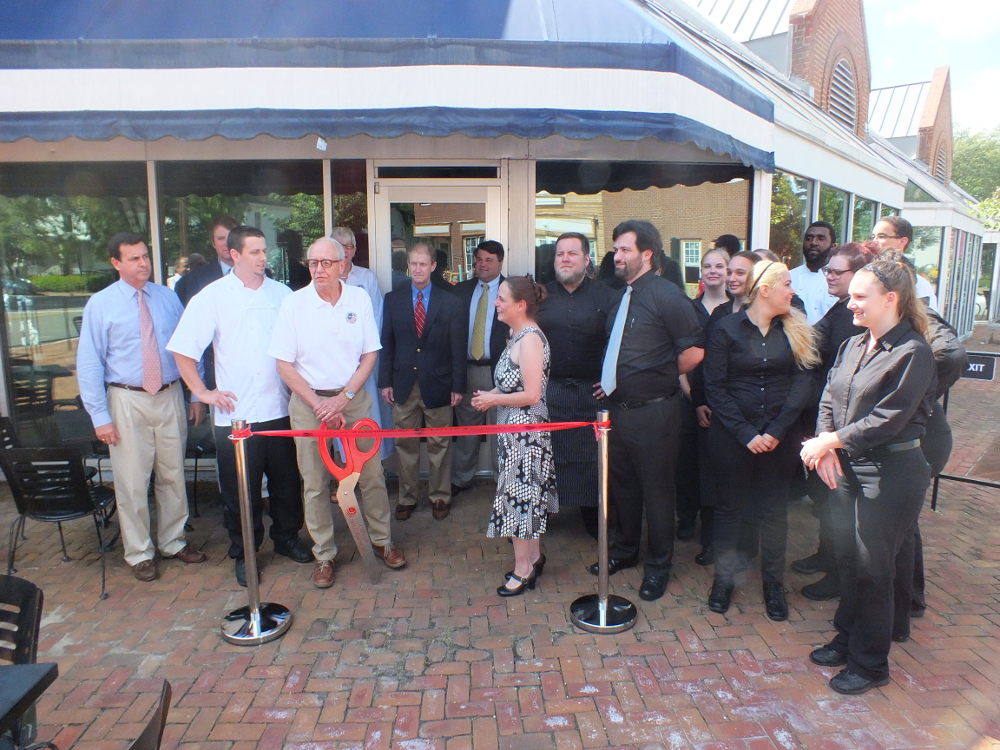 Mayor Clyde Haulman and owner Anna Krouse cut a ceremonial ribbon to celebrate the opening of Triangle. (Ian Brickey/WYDaily)