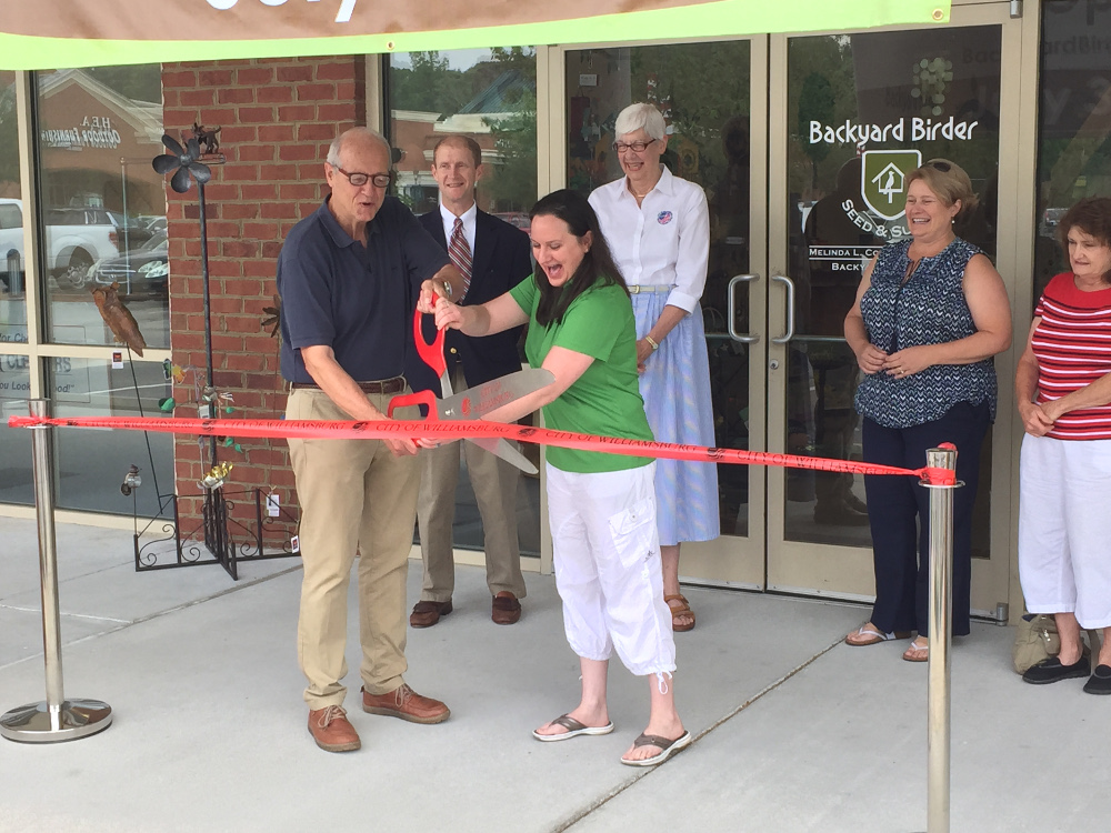 Mayor Clyde Haulman and Backyard Birder owner Melinda Cousins cut a ceremonial ribbon to open the store July 3. (Courtesy City of Williamsburg)