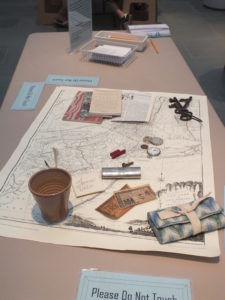 Visitors are asked to take one minute to try to memorize as many objects on this table as possible. (Elizabeth Hornsby, WYDaily)
