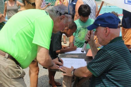A WAC member signs a petition in favor of reinstating Harold Baker as the head coach of WAC. (file photo)