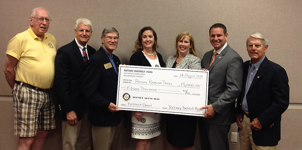 Officers of Rotary International District 7600 and local Rotary clubs present a check to the Williamsburg Regional Library. Left to right: Andy Robinson, Rotary Club of The Historic Triangle; John Enright, President-elect, Rotary Club of James City County; James A. Probsdorfer, Foundation Chair, Rotary International District 7600; Genevieve S. Owens, Director, Williamsburg Regional Library; Sandra Towers, Youth Services Director, Williamsburg Regional Library; Jason Blanchard, President, Rotary Club of The Historic Triangle; Chuck Hobson, President, Rotary Club of Williamsburg.