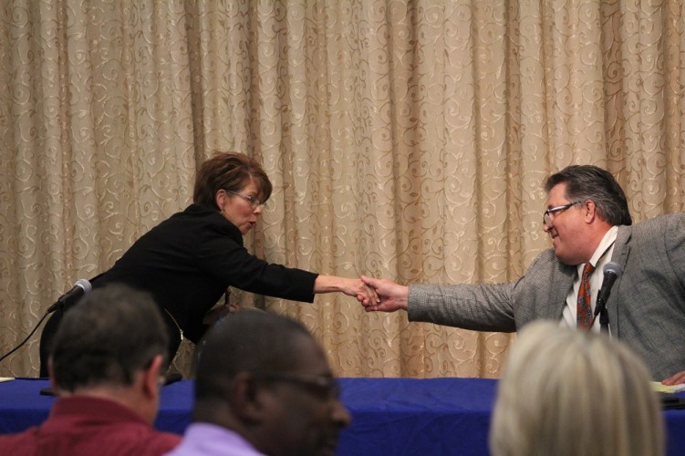 Sue Sadler (R) and Supervisor Jim Kennedy (I) shake hands after the Stonehouse District debate. (Ty Hodges/WYDaily)