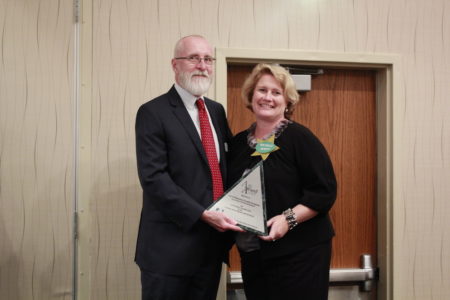 Fred Brayersdorfer, President of the Cultural Alliance of Greater Hampton Roads, presents the Alli Award to Michele Mixner DeWitt, Director of Economic Development for the City of Williamsburg. (Courtesy City of Williamsburg)