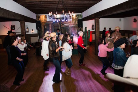 Cowboys and cowgirls line danced to country tunes thanks to Colonial DJs and Country Bootleggers Dance Studio. (Courtesy Jenn's Photography)
