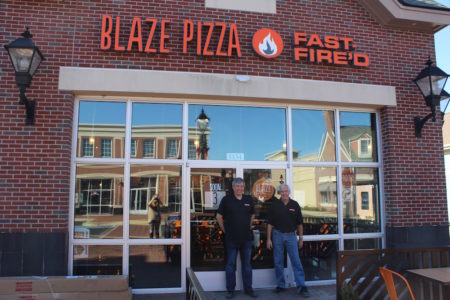 Franchise Partners Bob Parsons and Lamar Sale pose in front of Blaze Pizza in New Town, opening Thursday. (Elizabeth Hornsby/WYDaily) 