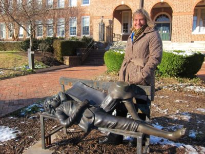 Julie Hummel, the newest City of Williamsburg representative on the WJCC School Board, stands outside Matthew Whaley Elementary School Jan. 18 with a statue of the school's namesake, which the PTA purchased when she was president after the school building's 75th anniversary in 2006. (Kirsten Petersen/ WYDaily)
