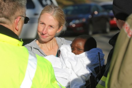 Eight-year-old Zeb Gross, pictured in the arms of his mother, Erin, was found in a crawl space under his Skipwith Farms home. (Ty Hodges/WYDaily)