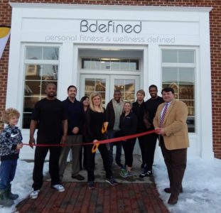 The Bdefined staff holds a ribbon cutting to celebrate its new location. (Photo courtesy of James City County)