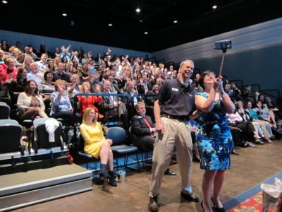 Leigh Houghland, chair of the GWCTA Board of Directors and Karen Riordan, president and CEO of GWCTA, take a selfie with attendees of the 2016 Tourism Forum March 11, 2016. (Kirsten Petersen/WYDaily)