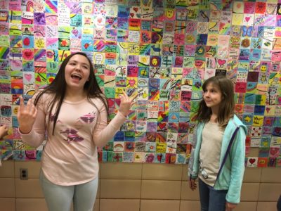 Eighth grader Tahlia Sloan, left, and sixth grader Brielle Boyd share the positive messages they created for the Builders Club's Project BeYOUtiful at Tabb Middle School. (Colin Riddle/WYDaily)