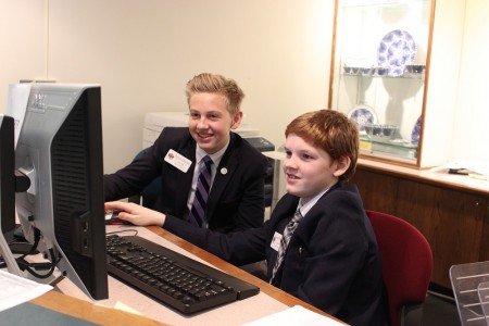Peyton Emerson (left) and his classmate, Gareth Vaughan of Richmond, staff an information desk on Capitol Square. (Senate Page Program)