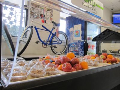 The smoothie bar at York High School features two flavors of smoothies, yogurt parfaits and whole fruit. The bicycle (background) will be given away through a raffle. (Kirsten Petersen/ WYDaily)