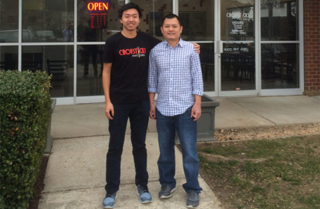 Chopsticks employee Duy Khang Nguyen (left) and Chopsticks owner Son Nguyen (right) post outside their new restaurant. (Photo courtesy of James City County)
