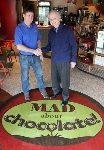 Mike Riordan (left) closes on his purchase of MAD About Chocolate from Marcel Desaulniers. (Courtesy of Riordan Enterprises LLC)