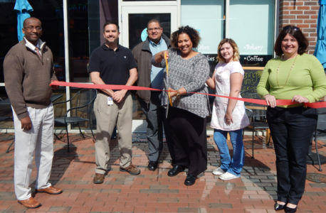 Lashonda Sanford cuts the ribbon at Scratch Bakery in New Town March 23. (JCC)