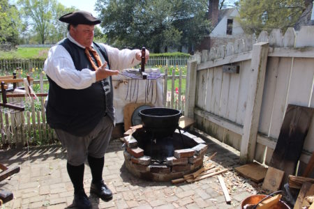 Interpreter John King demonstrates the dipping method of candle making. (Elizabeth Hornsby/WYDaily)