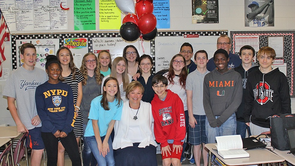 WJCC Teacher of the Year Shari Vandygriff (center) is surrounded by her students at Berkeley Middle School. Also pictured is WJCC School Board Chairman Jim Kelly (Jamestown). (WJCC Schools)