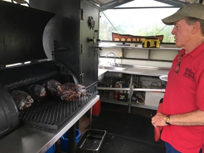 Joe Boone slow cooks his barbecue with a special rub from Henderson, Texas, on indirect heat from burning hickory or pecan wood. (Colin Riddle/WYDaily)