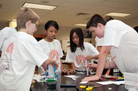 A group of students tinker during the Invention Project summer camp. (Photo courtesy of Invention Project)