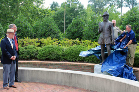 Bill Kelso and James Horn, of the Jamestown Rediscovery Project, watch as a statue of Capt. Bartholomew Gosnold is unveiled outside the WJCC courthouse on July 8. (Adrienne Berard/WYDaily)