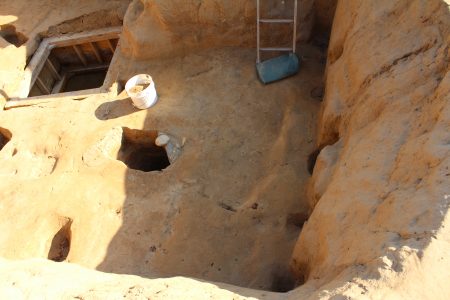 The three post holes along the wall likely supported the ceiling above the cellar, according to Danny Schmidt. The larger hole next to the bucket was likely robust enough to support a much larger structure. (Andrew Harris/WYDaily.)