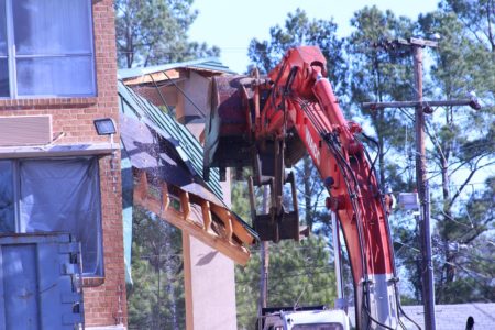 Crews used heavy equipment to begin demolishing the Super 8 Wednesday morning. (Andrew Harris/WYDaily)