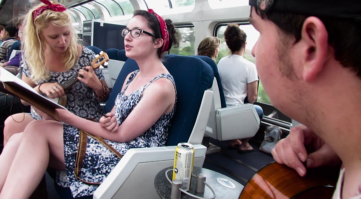Caroline Scruggs, left, Caroline Redick and Samuel Corey work on a song from inside the observation train car. (Photos courtesy Jeanette Corey)
