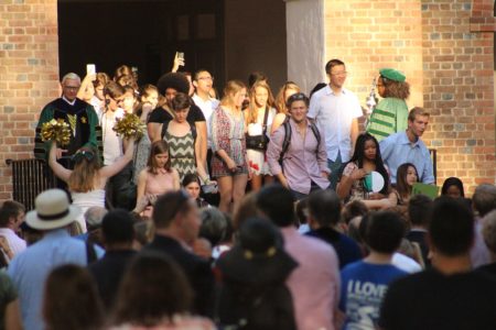 First-year William and Mary students exit the Wren Building during 2016 Convocation. President Reveley stand to the left and looks on. (Andrew Harris/WYDaily)