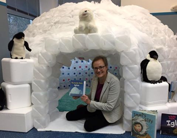 Interim Director Janet Crowther invites children and adults to curl up with a good book inside the library's reading igloo. (Courtesy Williamsburg Regional Library)
