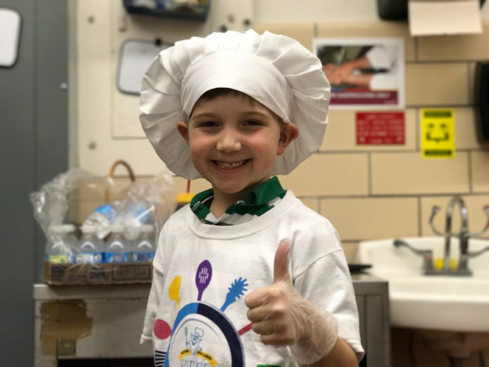 Nathanial Dunster gives a thumbs up while cooking a beef and potato pie. (Steve Roberts, Jr./WYDaily)