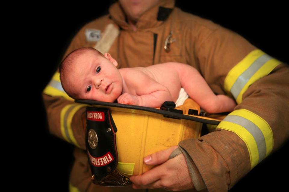 Amber and James Fox's son Carter lays inside James' firefighter helmet. Fox’s husband, James, has been working dozens of hours of mandatory overtime for several as a firefighter with York County Fire & Life Safety. (Courtesy Amber Fox)