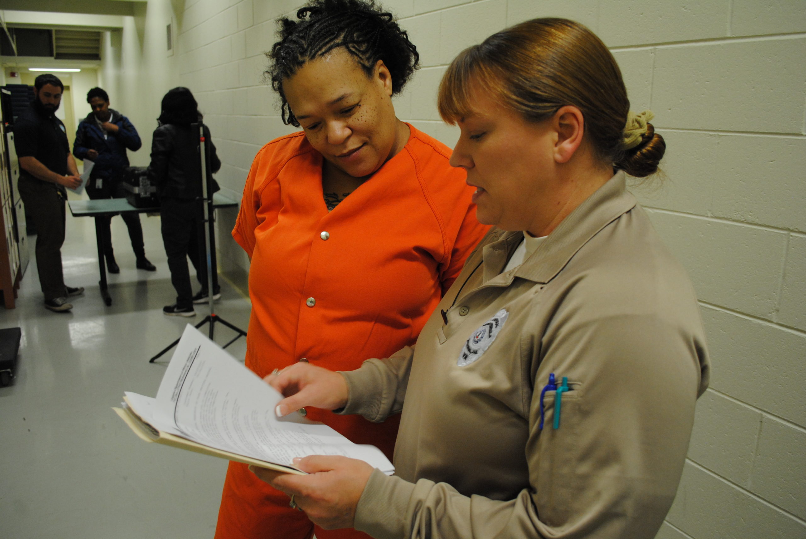 Crystal Stuckey goes over her compliance sheet with Cpl. Christina McCain. The sheet shows the steps Stuckey needs to take to reinstate her license. (Sarah Fearing/WYDaily)