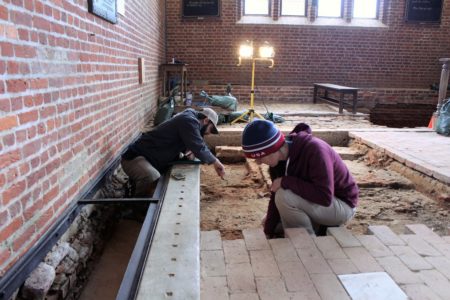 The interior Memorial Church at Historic Jamestowne. Archaeologists Mary Anna Hartley and Bob Chartrand excavate along the northern wall to the left of the frame. The chancel- the holiest place in the church- lies in the background along the eastern wall. (Andrew Harris/WYDaily)