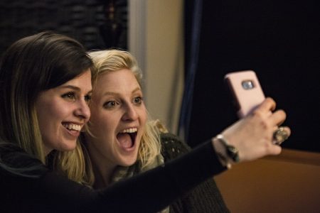 Jeanette Corey, left, and Caroline Scruggs take a photo while the American Train Collective records its debut album.