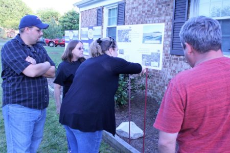 Mike (left) and Amanda Beringer show neighbors informational displays about SunPower's proposal for a solar farm adjacent to their neighborhood. (Andrew Harris/WYDaily)